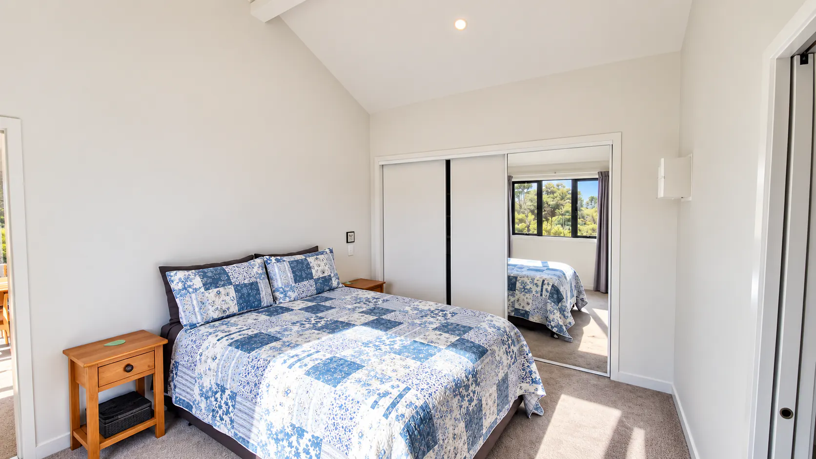 bach bedroom blue patchwork bed sandy bay motueka nz