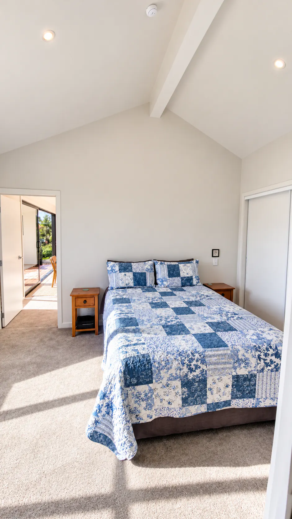 bach bedroom vaulted ceiling patchwork bed sandy bay motueka nz