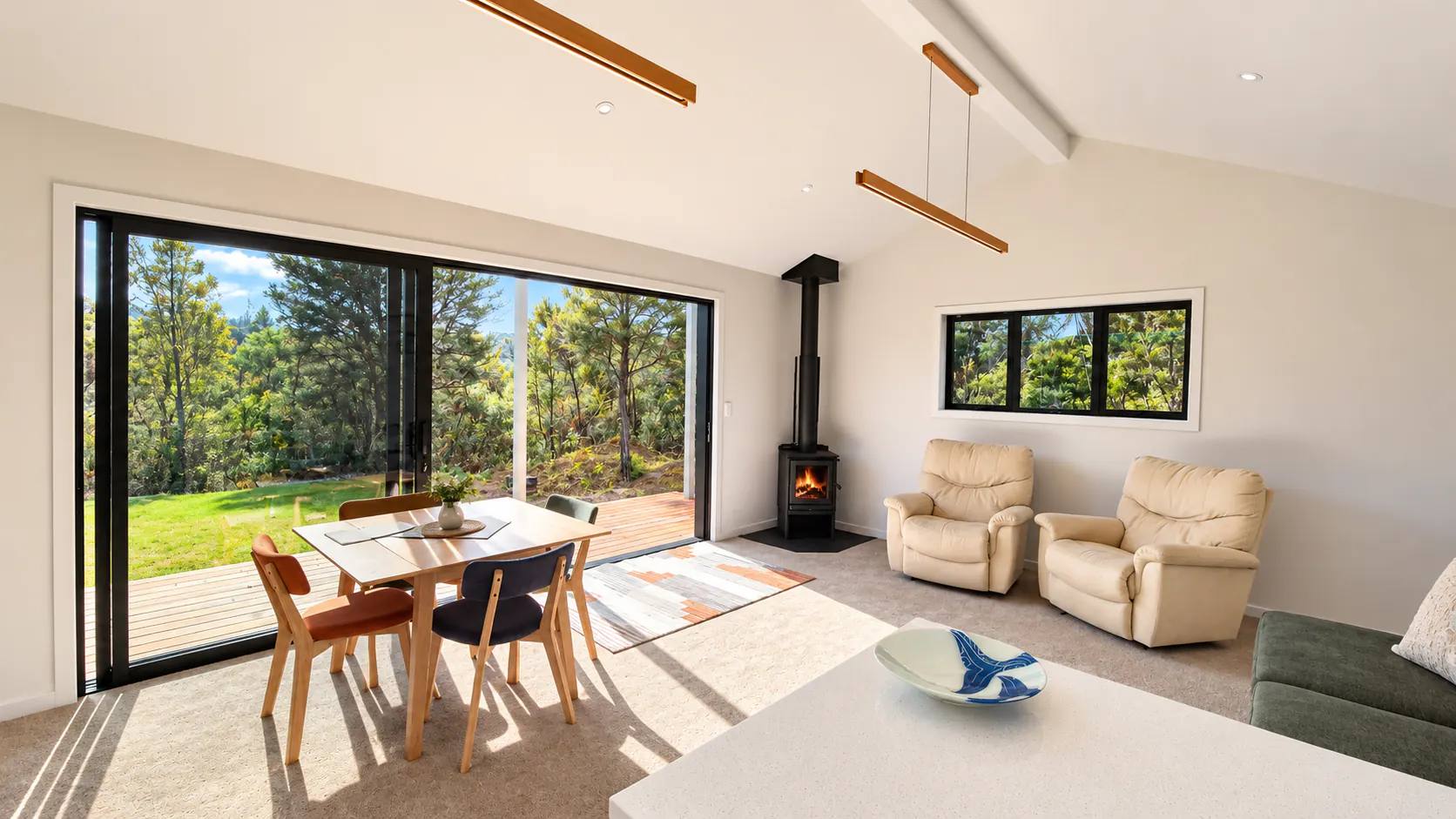 bach living room large feature door forest views sandy bay motueka nz