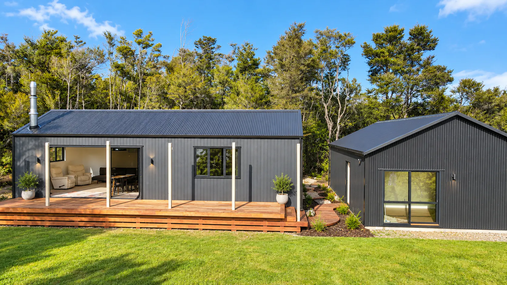 charcoal retirement bach among trees sandy bay motueka nz
