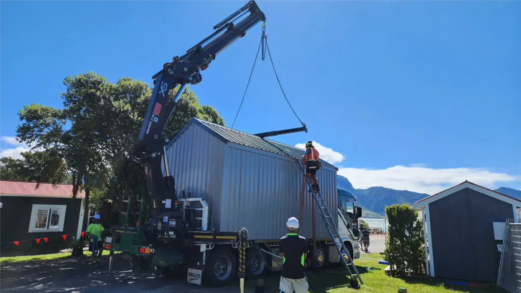 Crane lifting a Cosy Cabins holiday park cabin into place at Collingwood