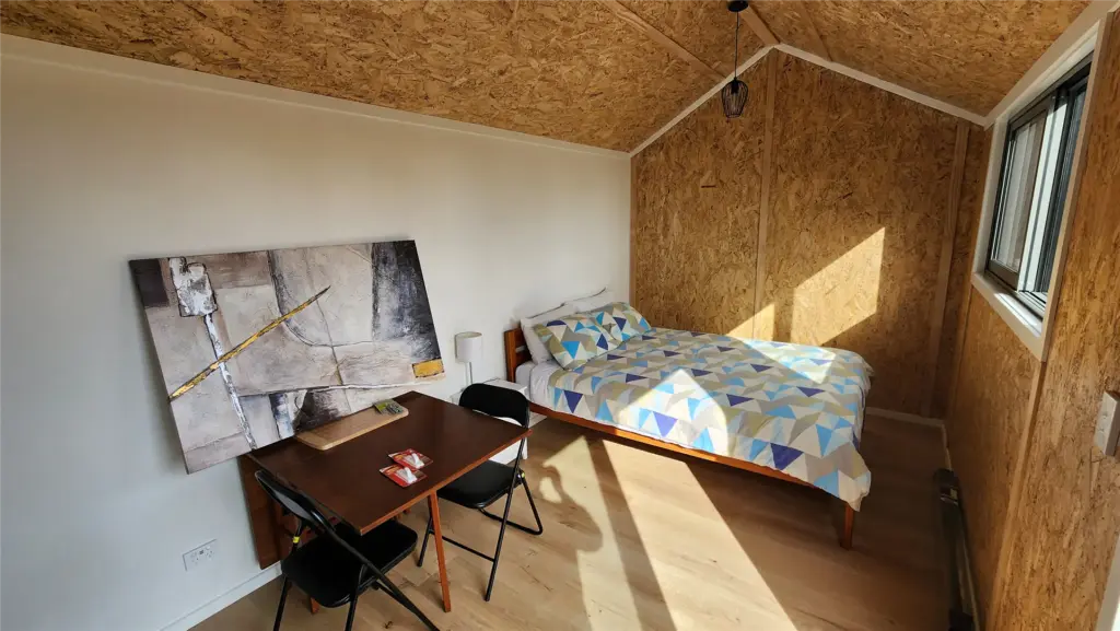 Interior of a holiday park cabin with a double bed at Collingwood