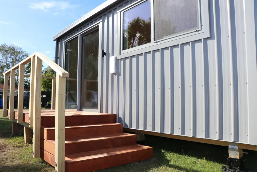 Holiday park cabin with grey cladding and kwila decking and steps