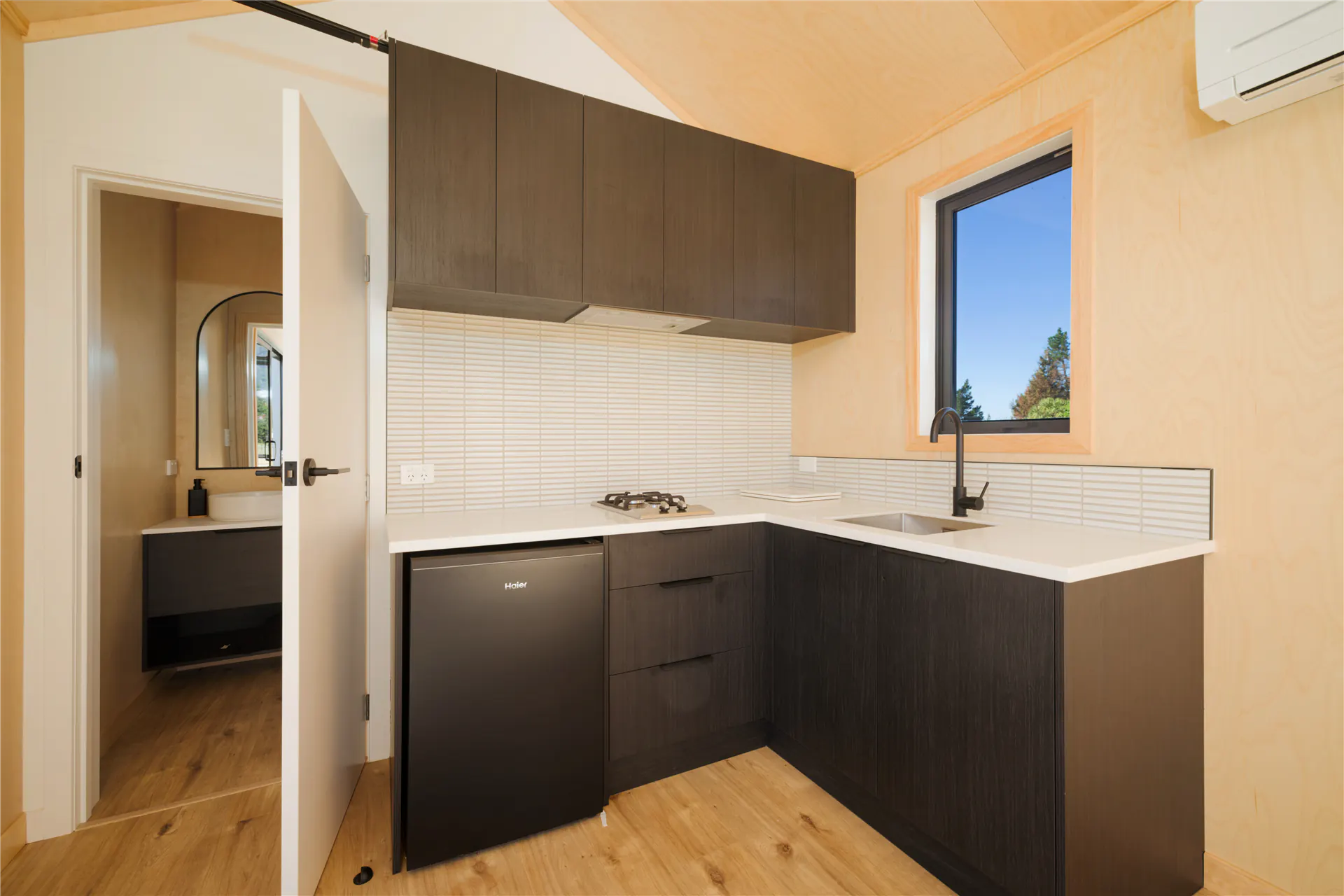 kaikoura bnb cabin kitchenette dark cabinetry nz
