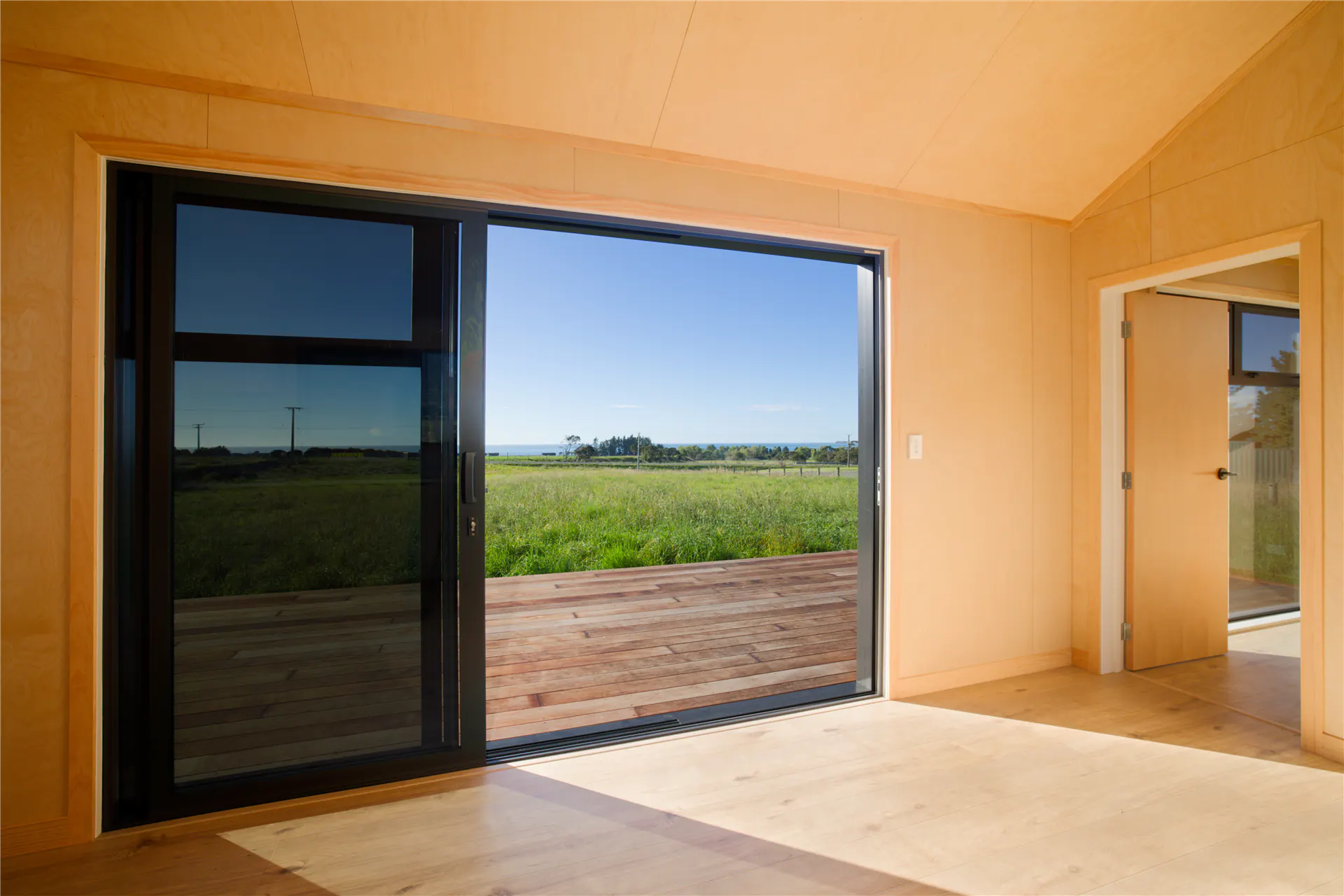 kaikoura bnb cabin living area large window farm views nz