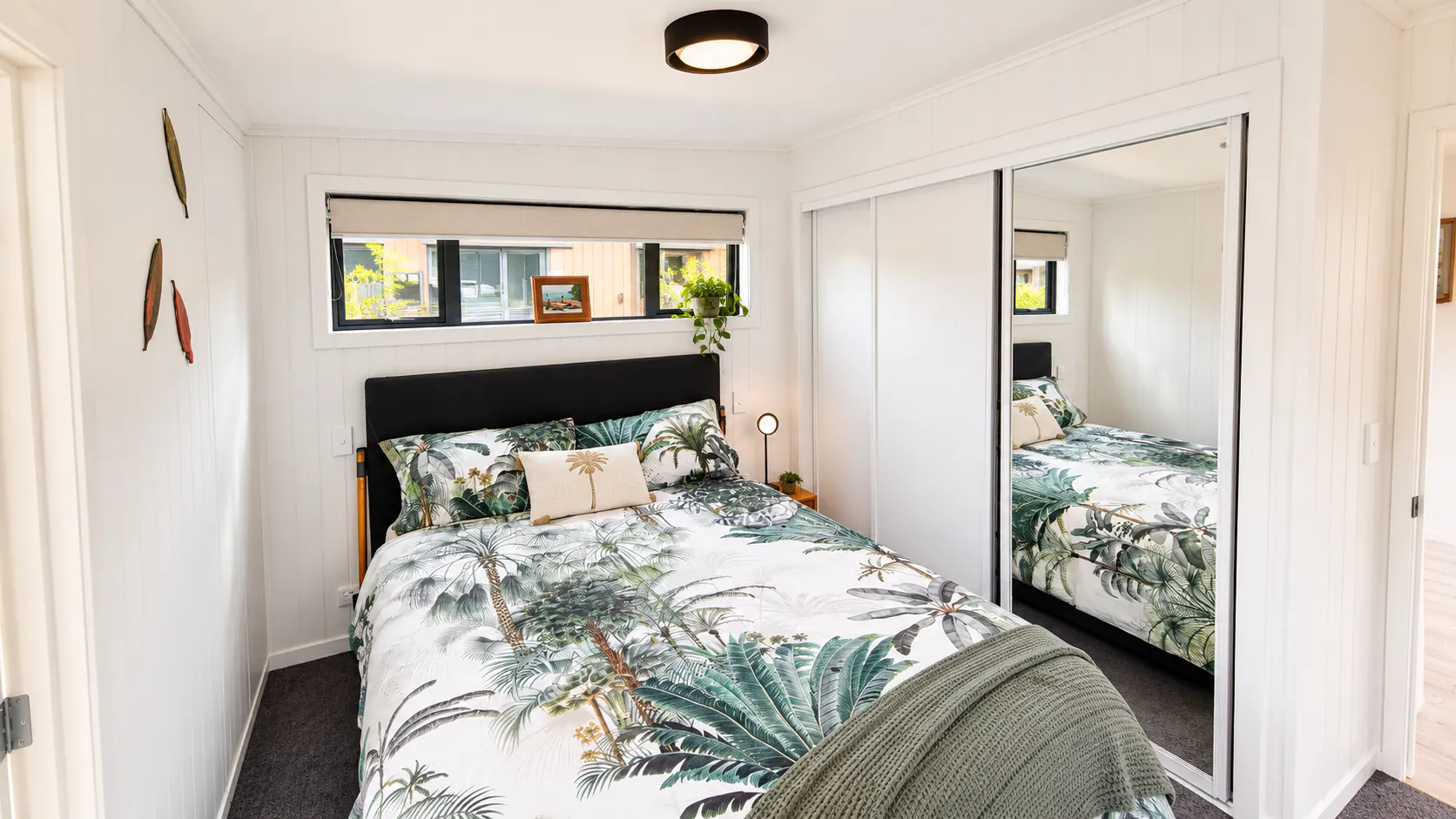 tiny home bedroom mirrored wardrobe bethany park kaiteriteri nz