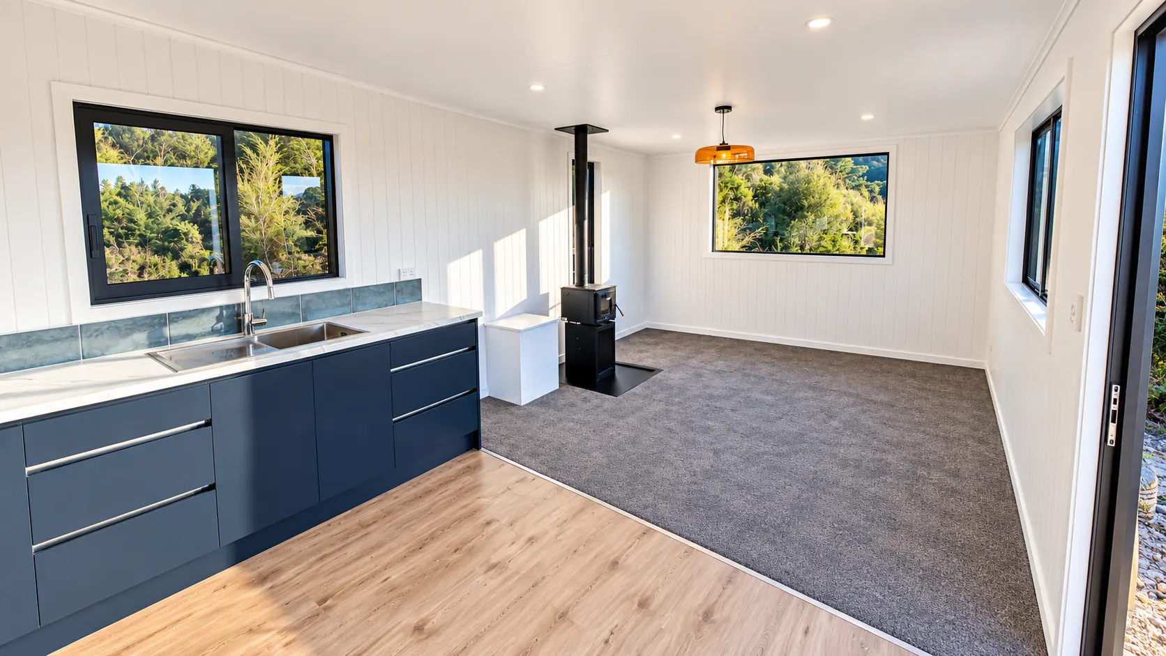 tiny home kitchen living area navy cabinets takaka hill nz