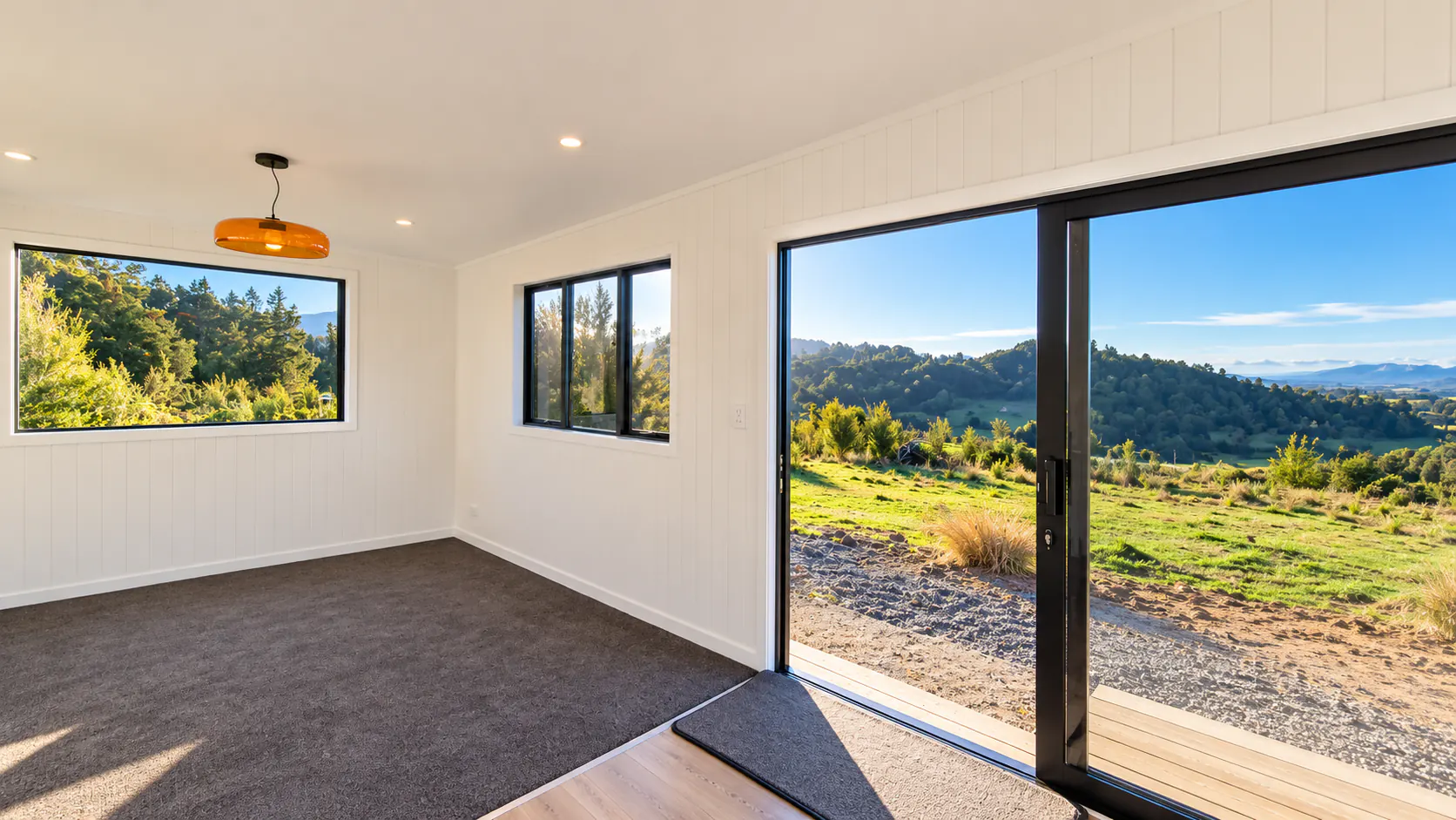 tiny home living room sliding door mountain views takaka hill nz
